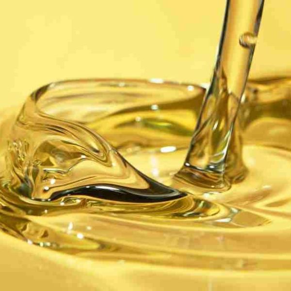Freeze motion of pouring oil, super macro shot.
